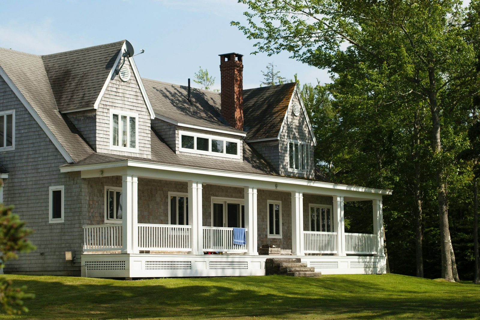 white and brown wooden house near green trees during daytime, home